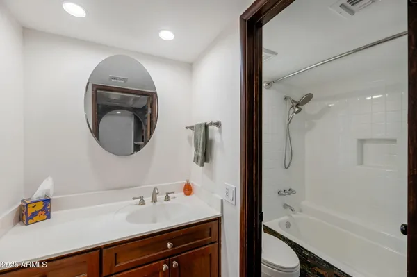 a bathroom with a sink a toilet and a mirror