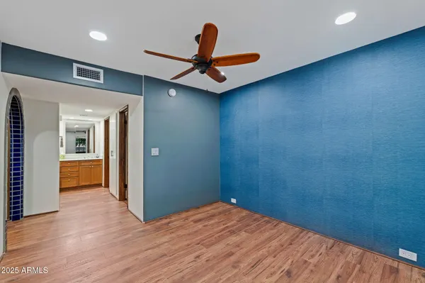 a view of empty room with wooden floor