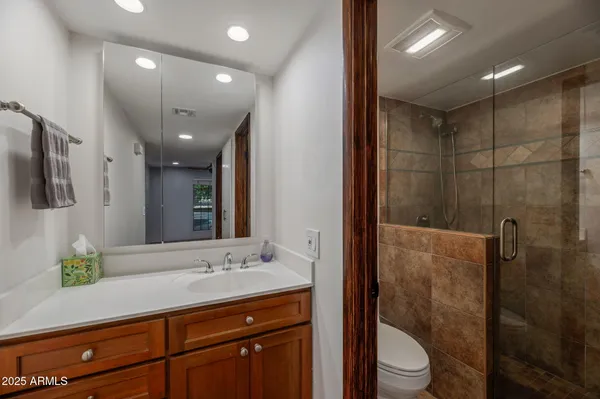 a bathroom with a sink a toilet and shower