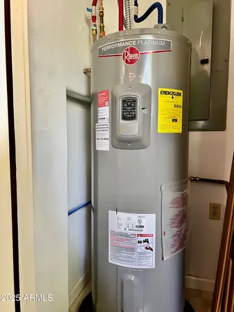 a view of a white house with a yard and potted plants