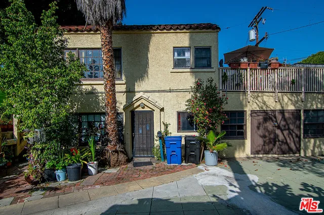 a view of a house with brick walls and potted plants