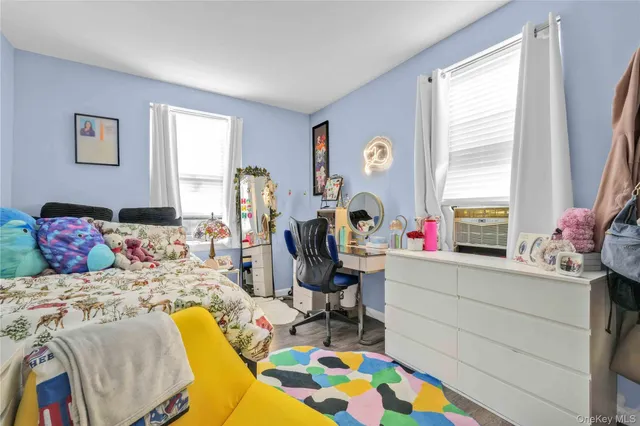 a bed sitting in a bedroom and chandelier