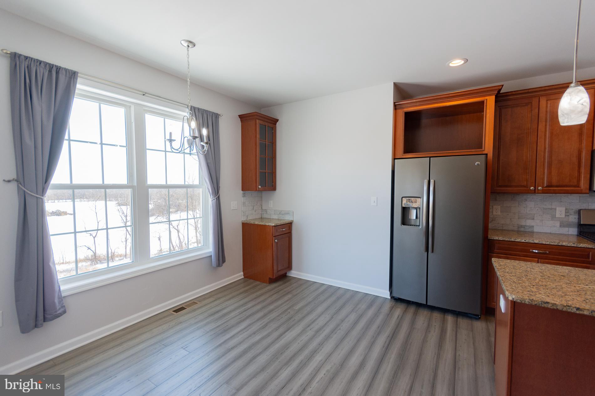 528 Delmar Orchard Road Martinsburg, WV 25403 - Photo 13 of 72 a kitchen with stainless steel appliances granite countertop a refrigerator a sink and wooden cabinets