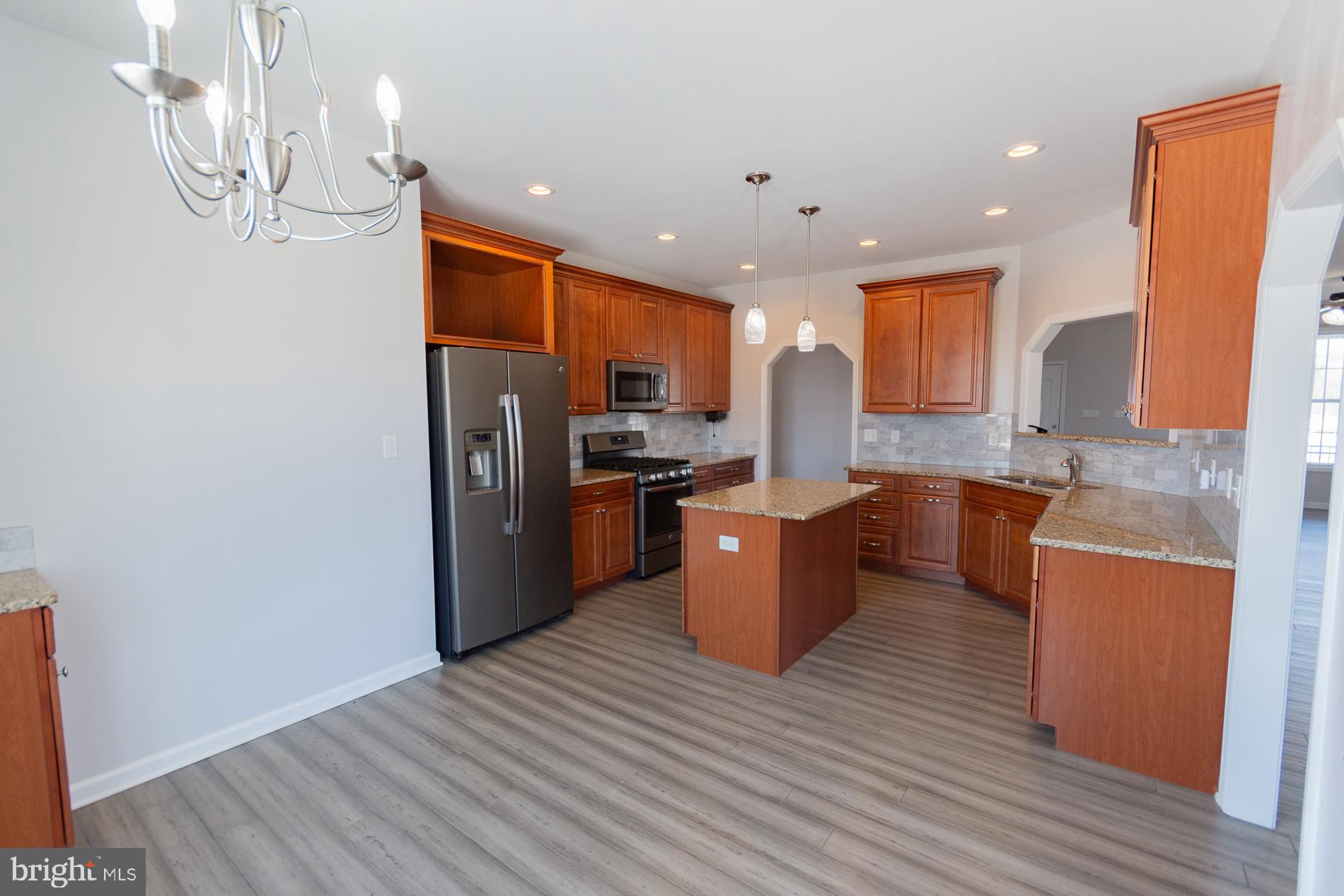 528 Delmar Orchard Road Martinsburg, WV 25403 - Photo 14 of 72 a kitchen with stainless steel appliances granite countertop a refrigerator a stove top oven a sink and dishwasher