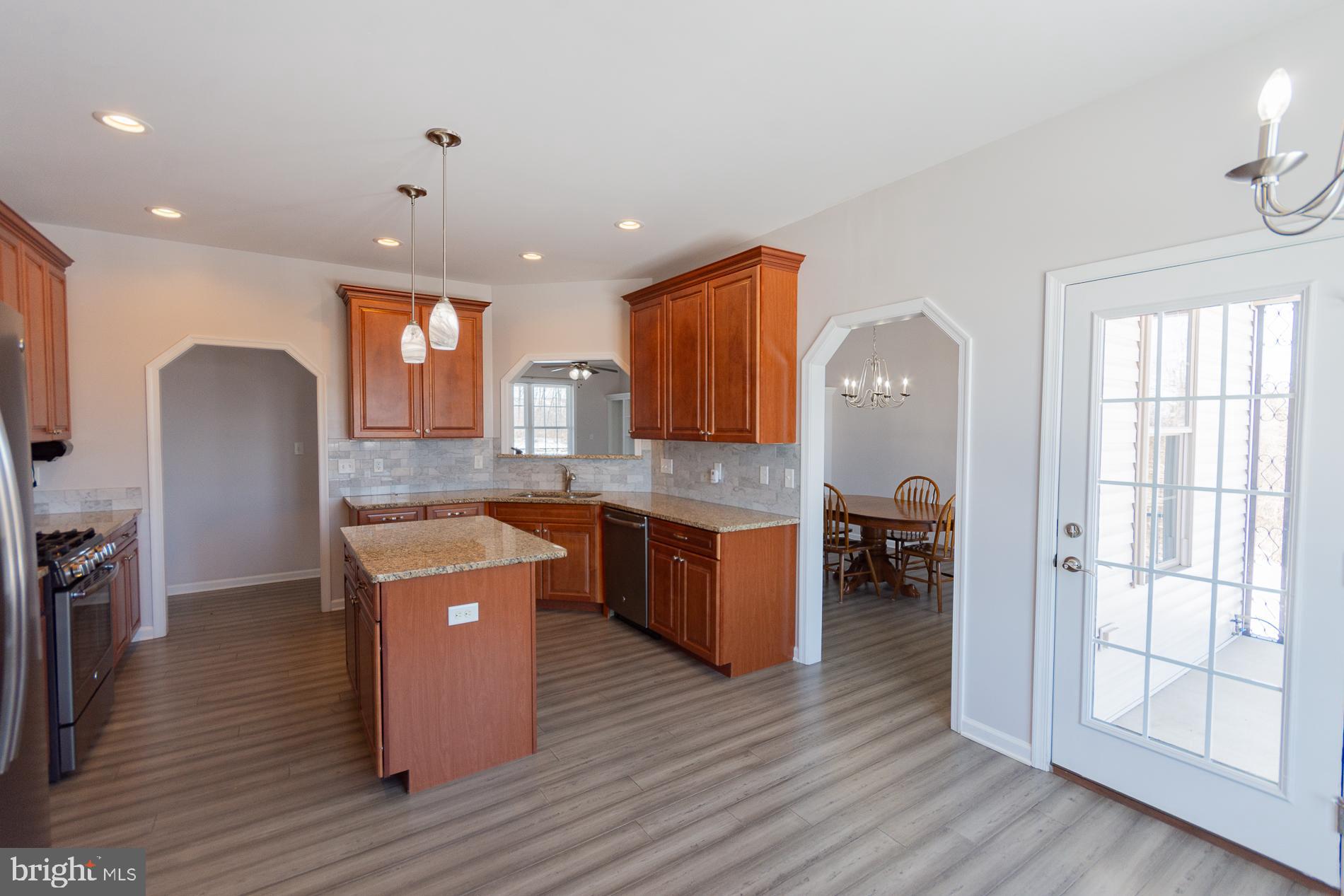 528 Delmar Orchard Road Martinsburg, WV 25403 - Photo 15 of 72 a kitchen with granite countertop a sink cabinets and wooden floor