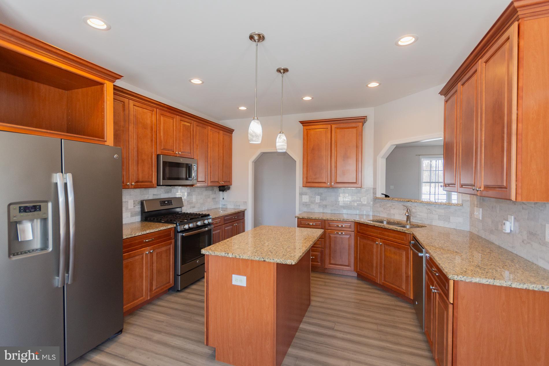 528 Delmar Orchard Road Martinsburg, WV 25403 - Photo 19 of 72 a kitchen with stainless steel appliances granite countertop sink stove refrigerator and cabinets