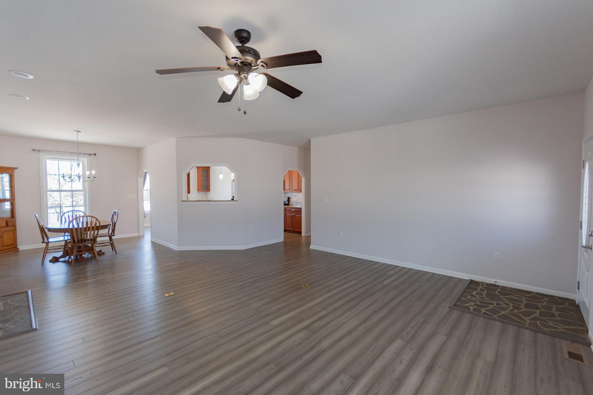 528 Delmar Orchard Road Martinsburg, WV 25403 - Photo 2 of 72 a view of empty room with wooden floor and windows