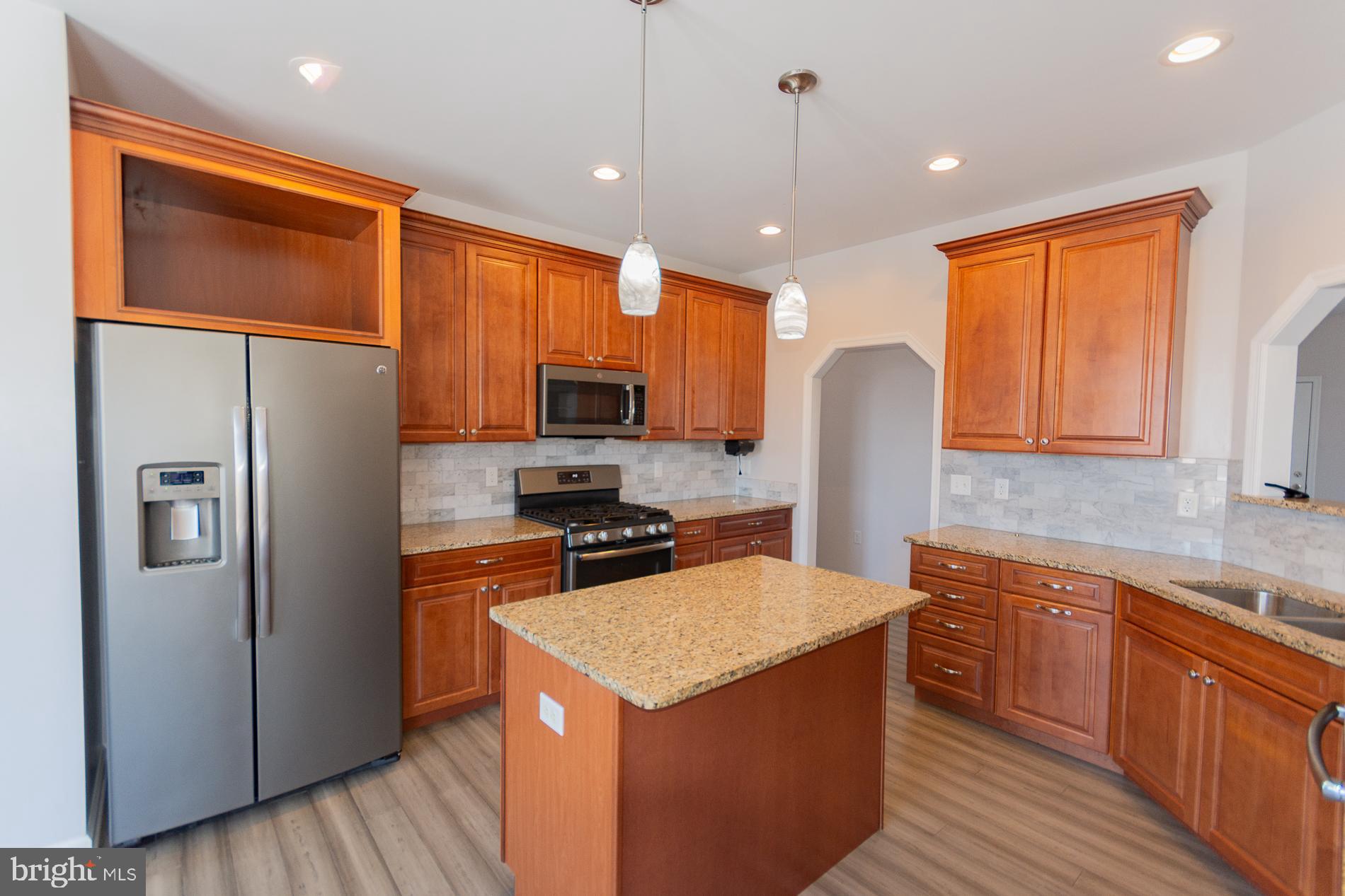 528 Delmar Orchard Road Martinsburg, WV 25403 - Photo 21 of 72 a kitchen with stainless steel appliances granite countertop a refrigerator a sink dishwasher a oven and a dining table with wooden cabinet