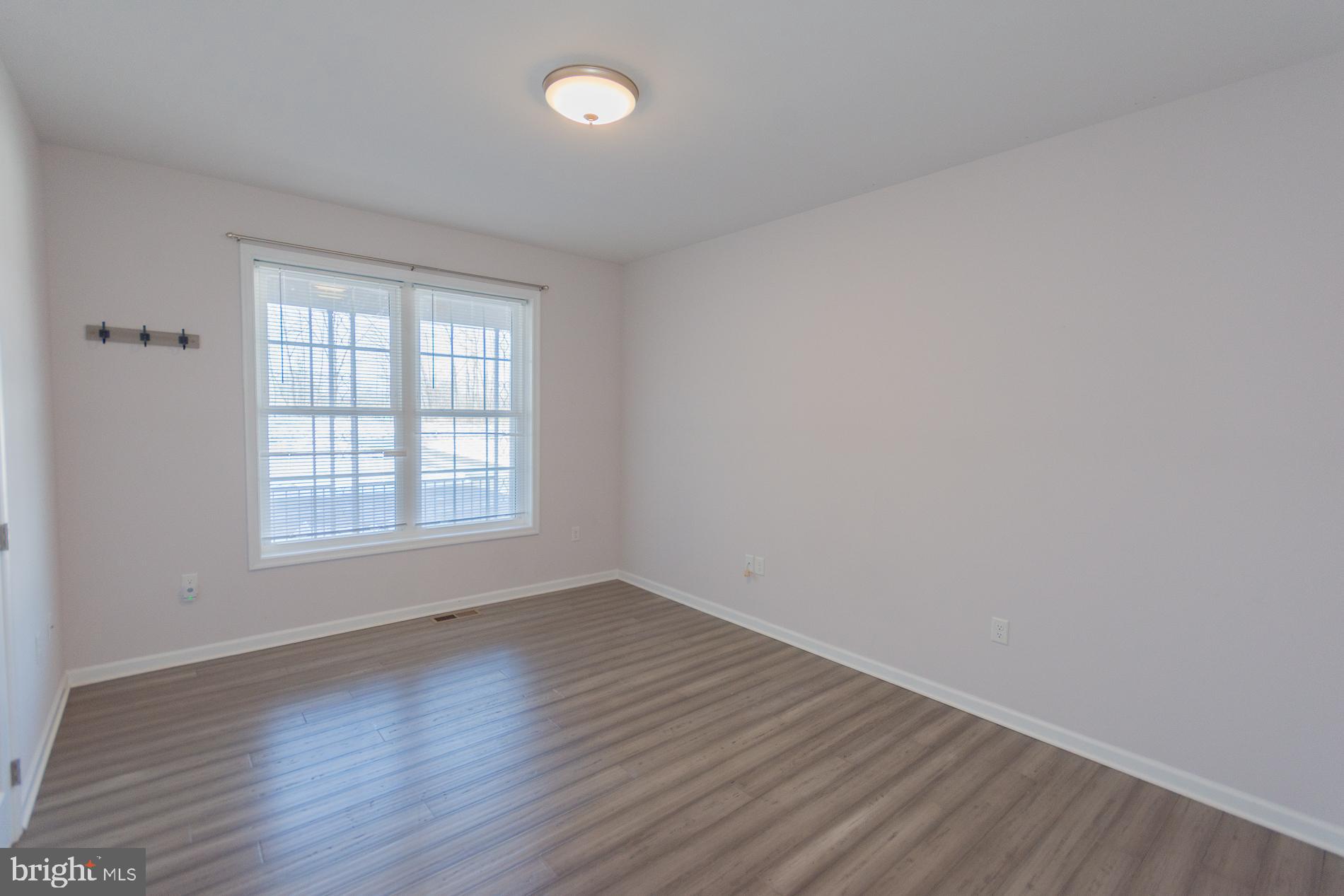 528 Delmar Orchard Road Martinsburg, WV 25403 - Photo 26 of 72 an empty room with wooden floor and windows