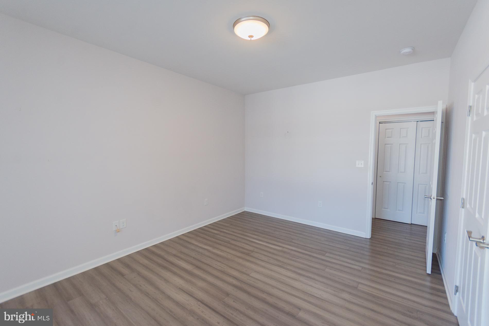 528 Delmar Orchard Road Martinsburg, WV 25403 - Photo 27 of 72 a view of an empty room with wooden floor and a window