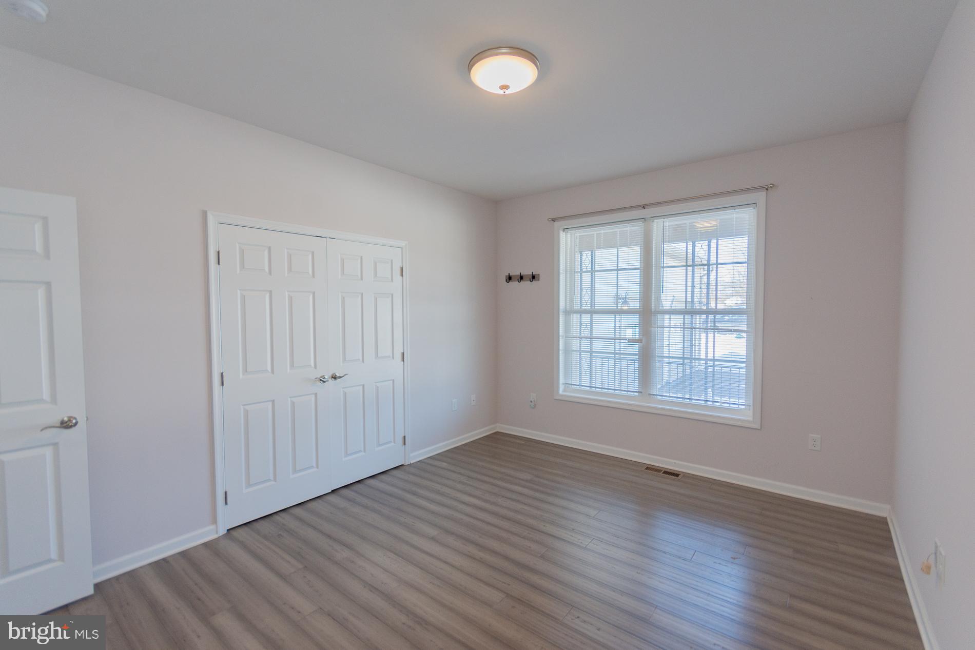 528 Delmar Orchard Road Martinsburg, WV 25403 - Photo 29 of 72 an empty room with wooden floor and windows