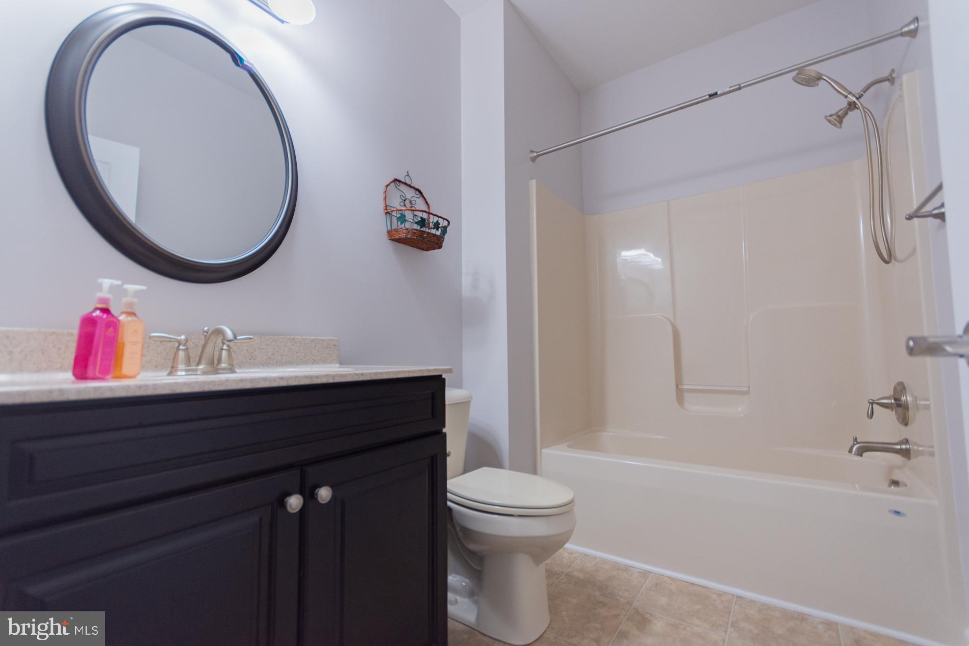 528 Delmar Orchard Road Martinsburg, WV 25403 - Photo 35 of 72 a bathroom with a sink vanity mirror and toilet