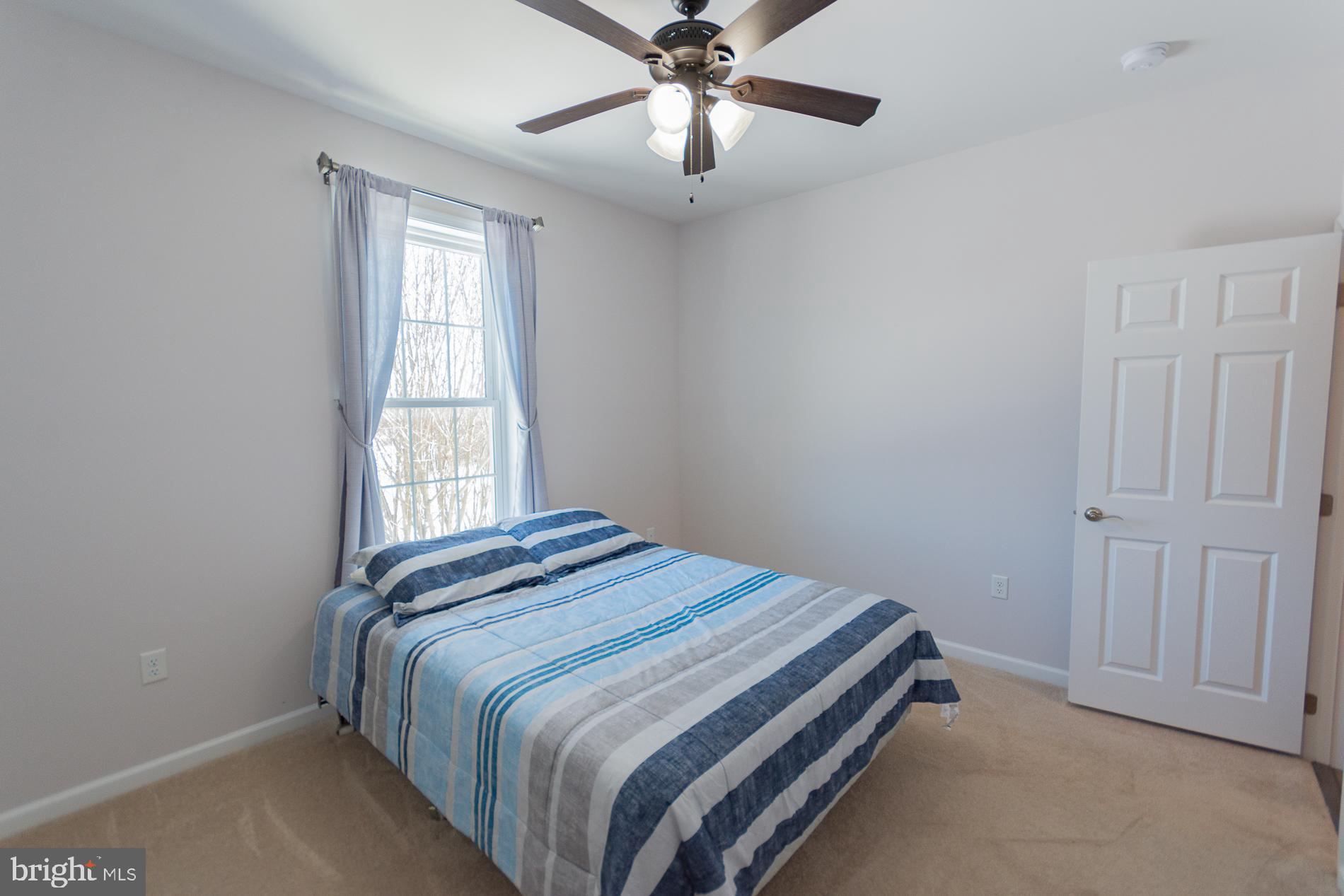 528 Delmar Orchard Road Martinsburg, WV 25403 - Photo 37 of 72 a bedroom with a bed and window