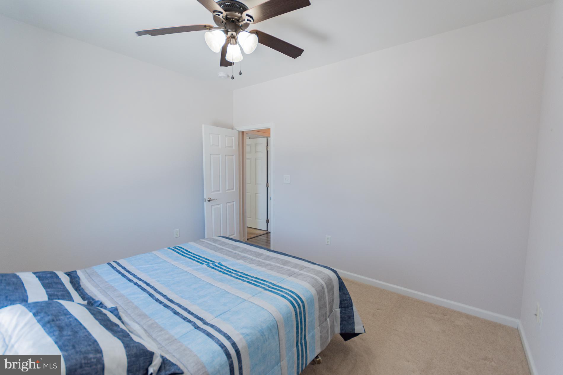 528 Delmar Orchard Road Martinsburg, WV 25403 - Photo 38 of 72 a bedroom with a bed and a chandelier fan