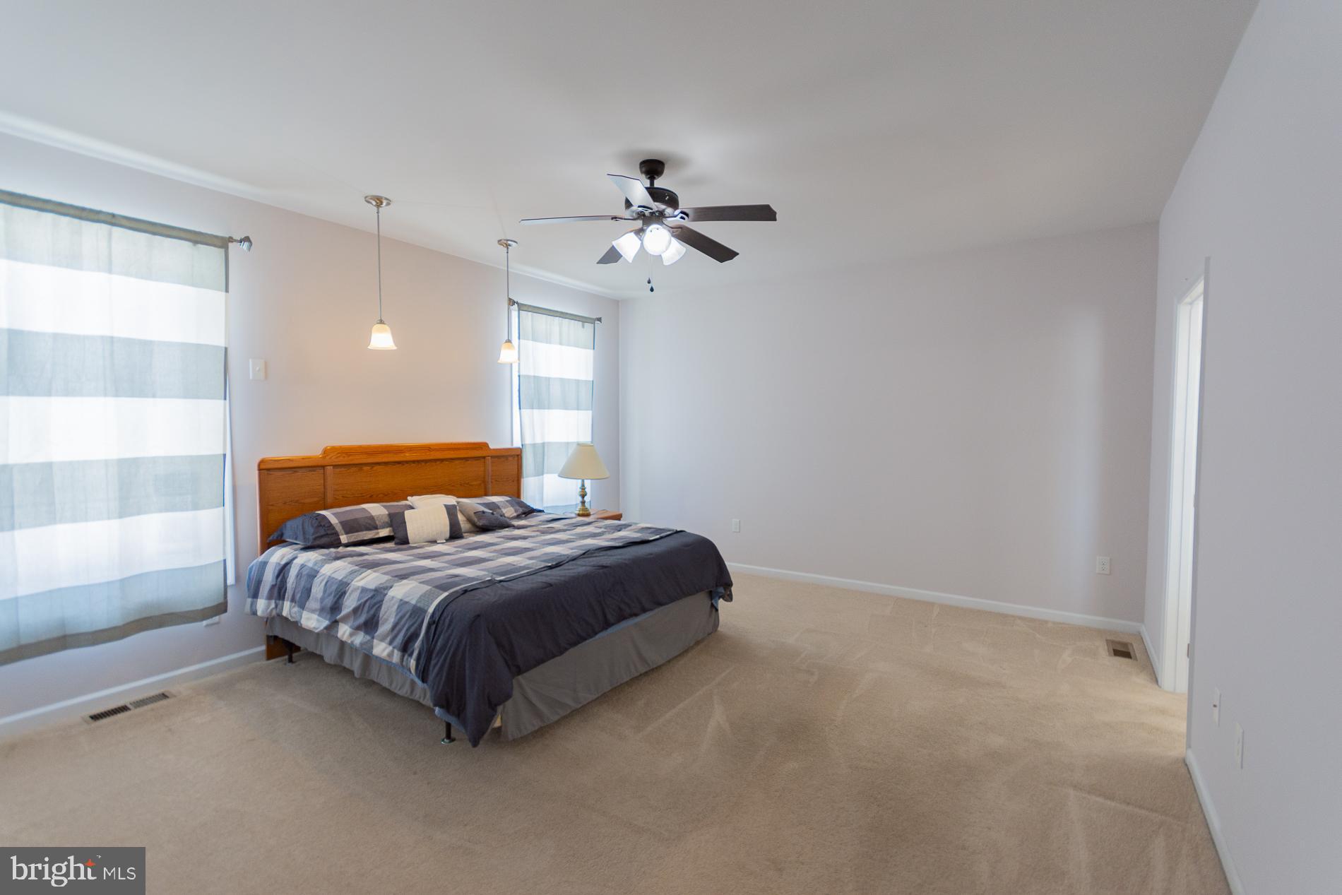 528 Delmar Orchard Road Martinsburg, WV 25403 - Photo 40 of 72 a bedroom with a bed chandelier and a window