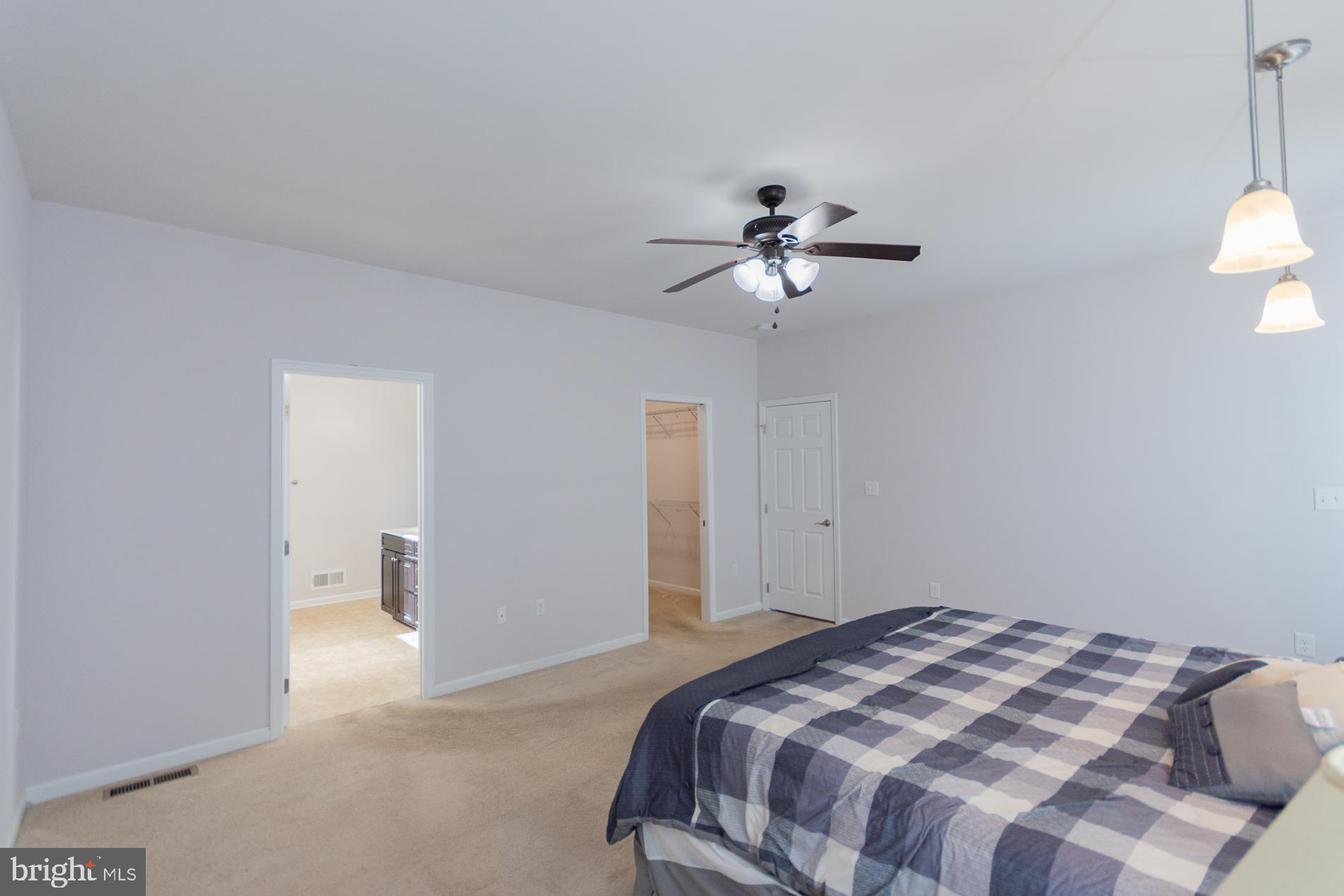528 Delmar Orchard Road Martinsburg, WV 25403 - Photo 42 of 72 a bedroom with a large bed and a chandelier