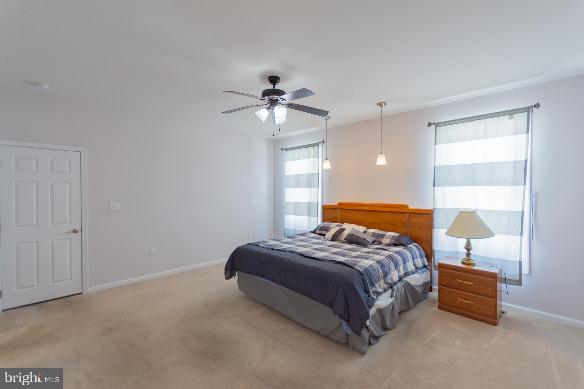 528 Delmar Orchard Road Martinsburg, WV 25403 - Photo 43 of 72 a bedroom with a bed and a chandelier