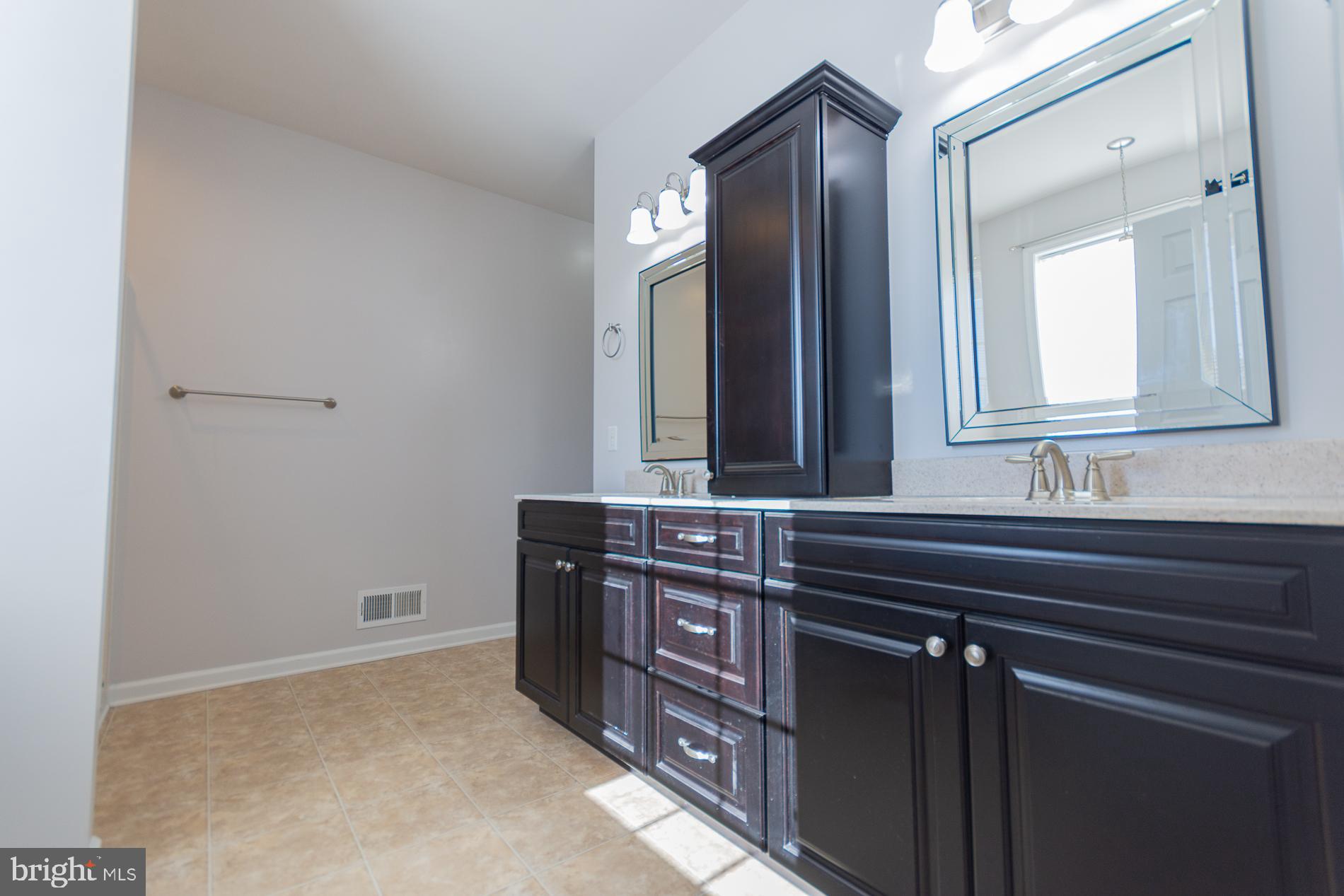 528 Delmar Orchard Road Martinsburg, WV 25403 - Photo 44 of 72 a bathroom with a sink a vanity and a mirror