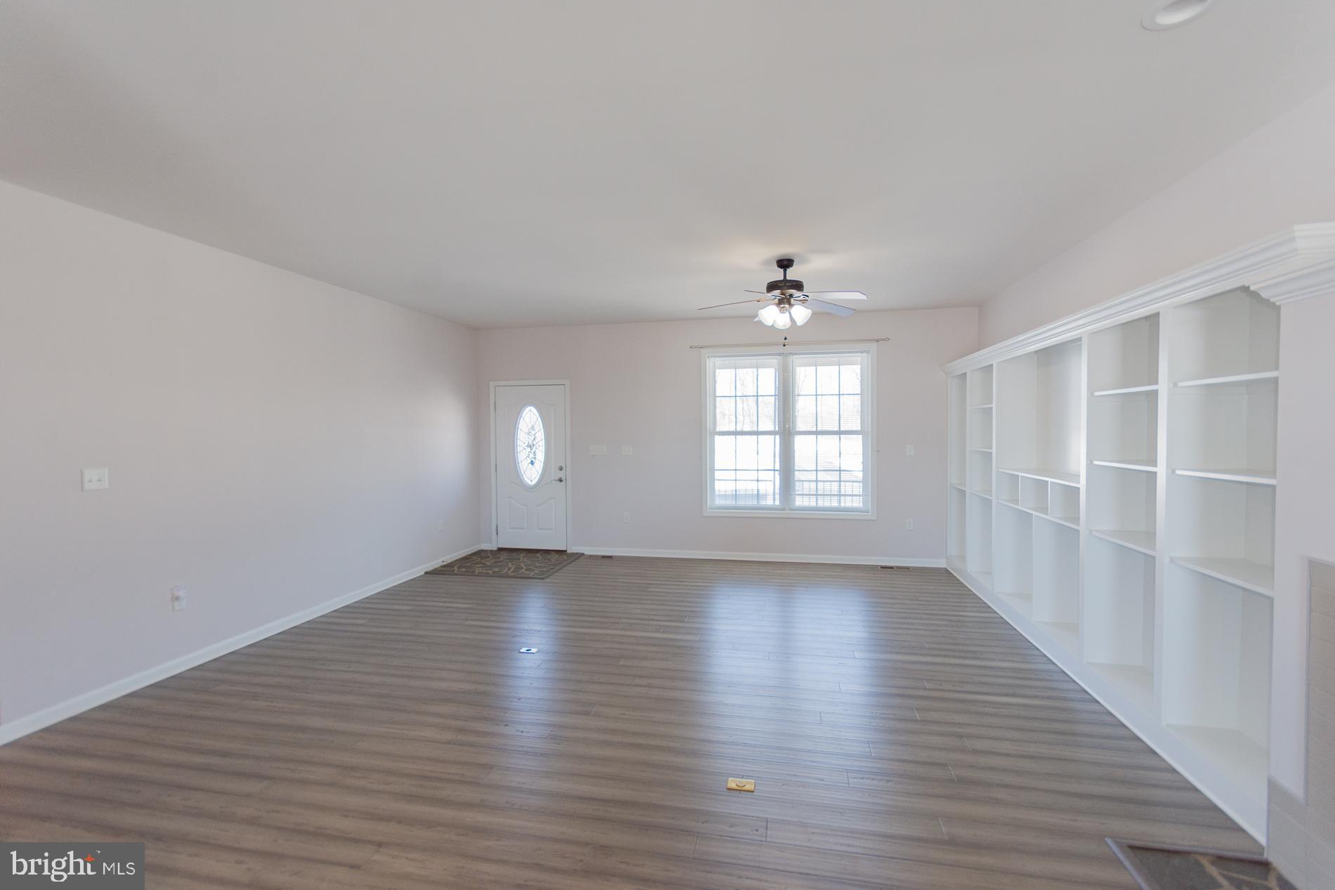 528 Delmar Orchard Road Martinsburg, WV 25403 - Photo 5 of 72 an empty room with wooden floor and windows