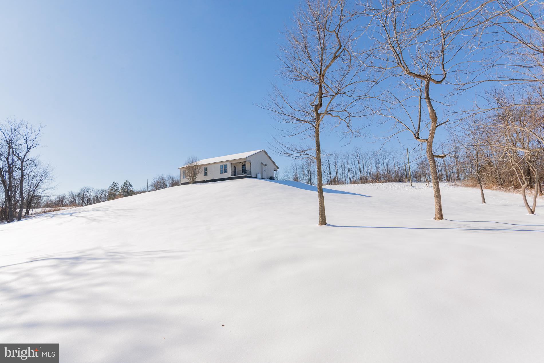 528 Delmar Orchard Road Martinsburg, WV 25403 - Photo 59 of 72 a view of a white house with a snow on the road