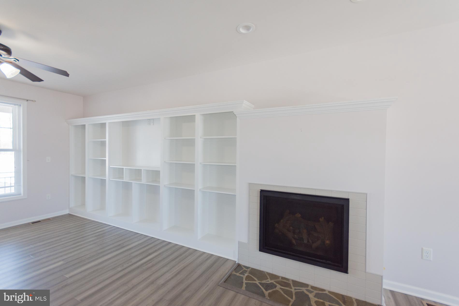 528 Delmar Orchard Road Martinsburg, WV 25403 - Photo 6 of 72 a view of an empty room with wooden floor and a window