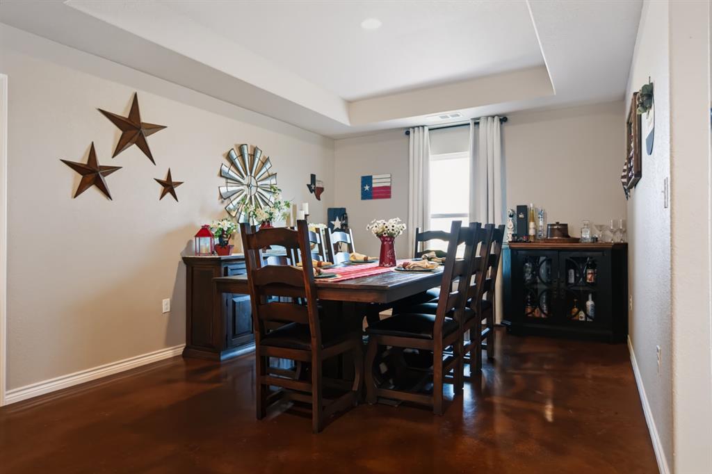 2433 Trlica Road West, TX 76691 - Photo 8 of 40 Recessed lighting, tray ceiling, neutral wall color, and dark-toned flooring