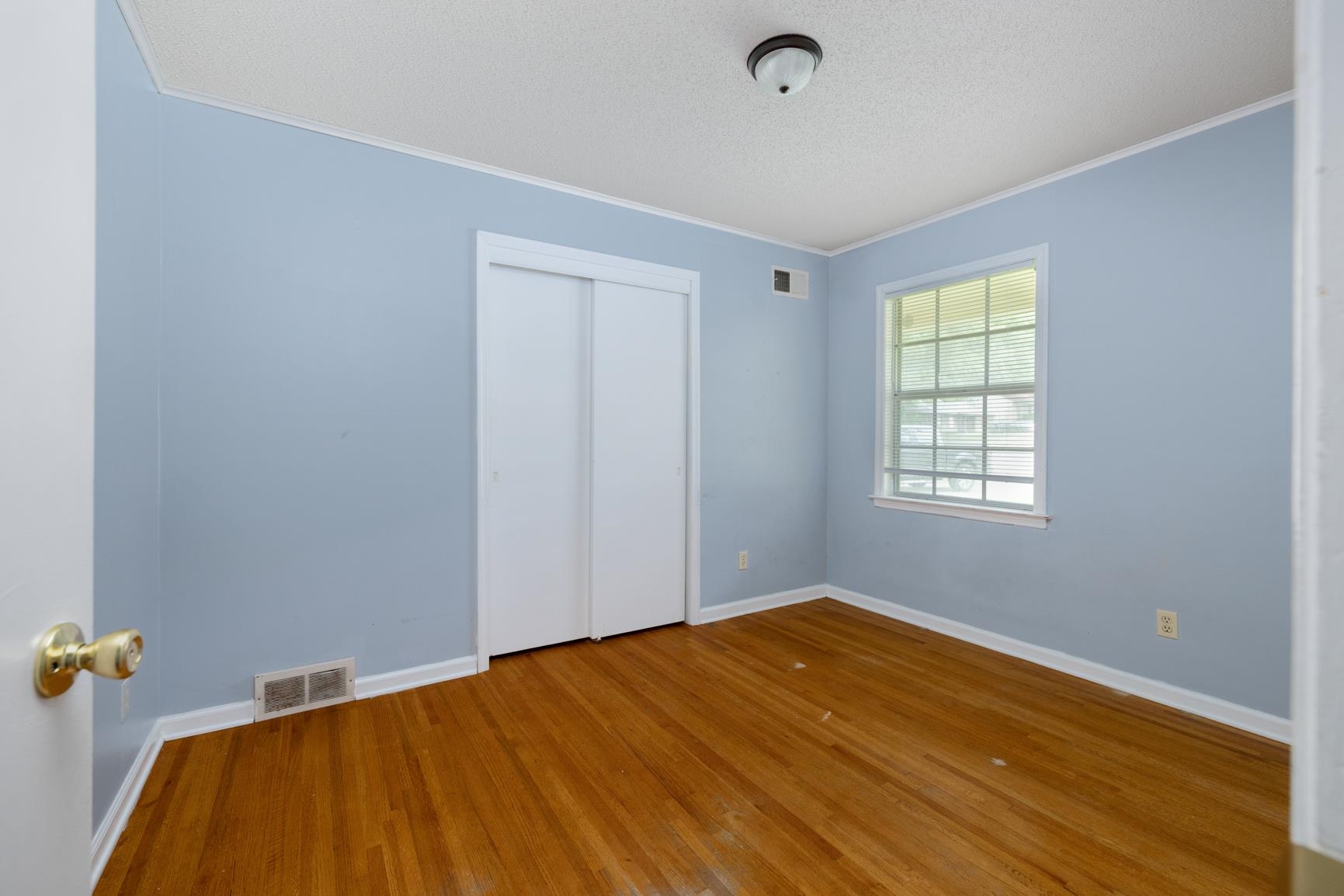 3853 Range Line Road Memphis, TN 38127 - Photo 10 of 18 Unfurnished bedroom with baseboards, wood finished floors, visible vents, and crown molding