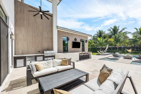a living room with fireplace furniture and a large window