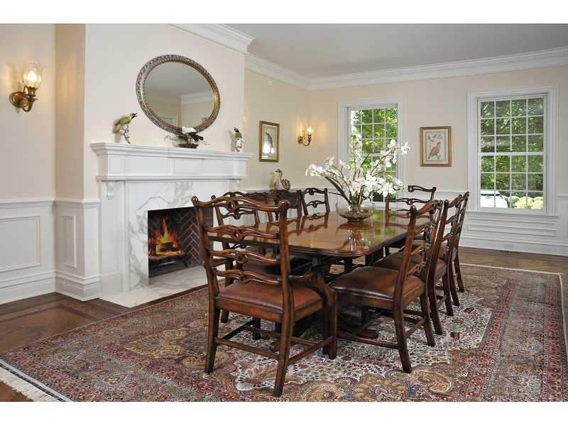 47 Round Hill Road Greenwich, CT 06831 - Photo 11 of 22 a dining room with furniture a fireplace and wooden floor