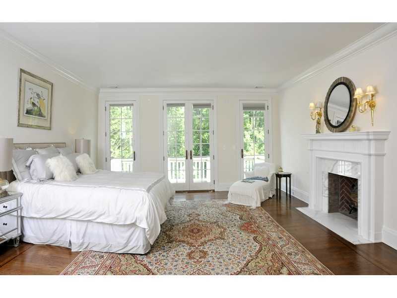 47 Round Hill Road Greenwich, CT 06831 - Photo 16 of 22 a bedroom with a bed and a fireplace