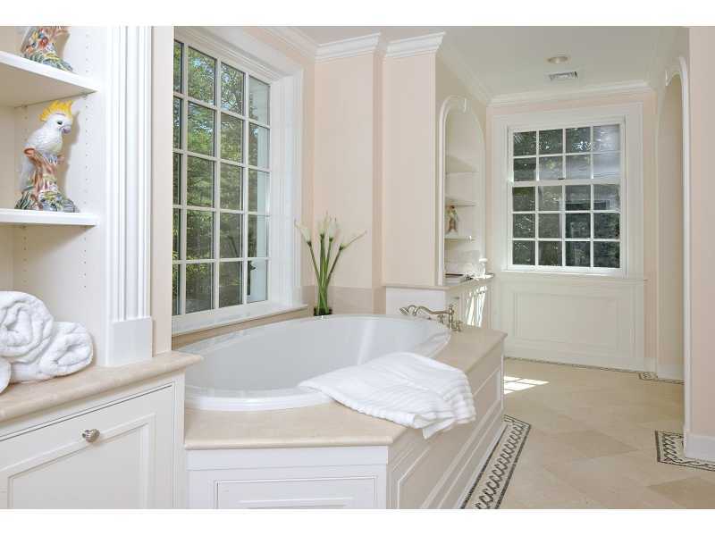 47 Round Hill Road Greenwich, CT 06831 - Photo 18 of 22 a bathroom with a granite countertop sink a mirror and a bathtub
