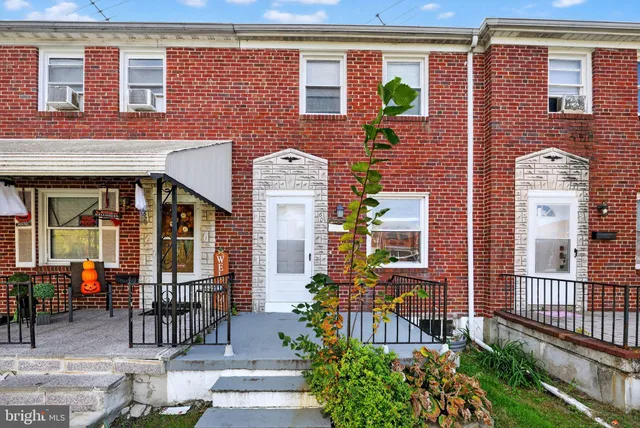 a front view of a brick building with large windows