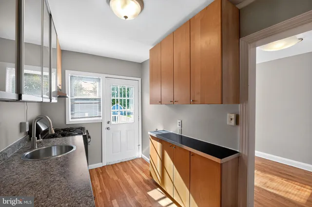 a kitchen with stainless steel appliances granite countertop a sink stove and cabinets