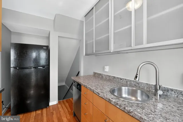 a kitchen with a refrigerator and a sink