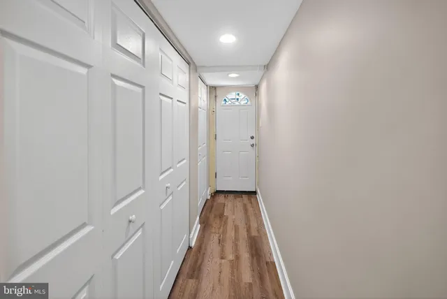 a view of a hallway with wooden floor