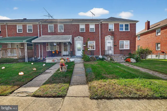 a front view of brick house with a yard