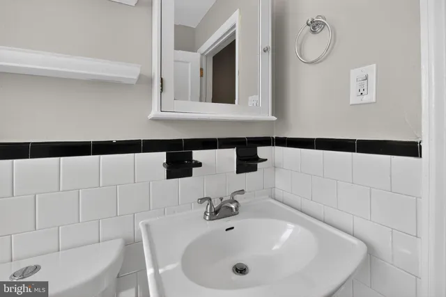 a bathroom with a sink and mirror