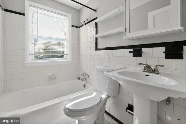 a bathroom with a sink a toilet and bathtub
