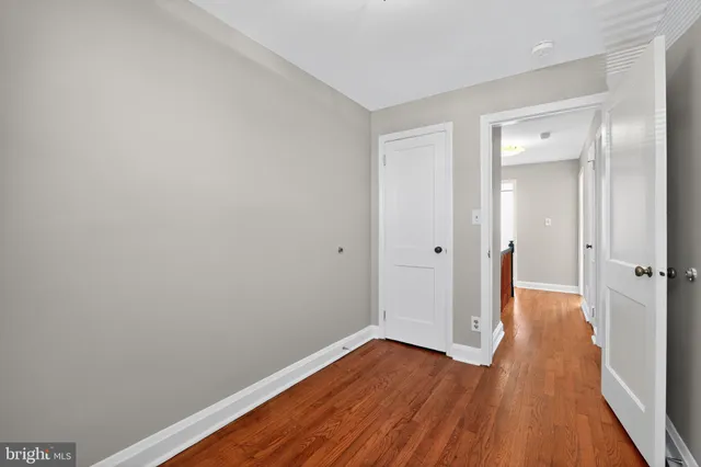 a view of a room with wooden floor