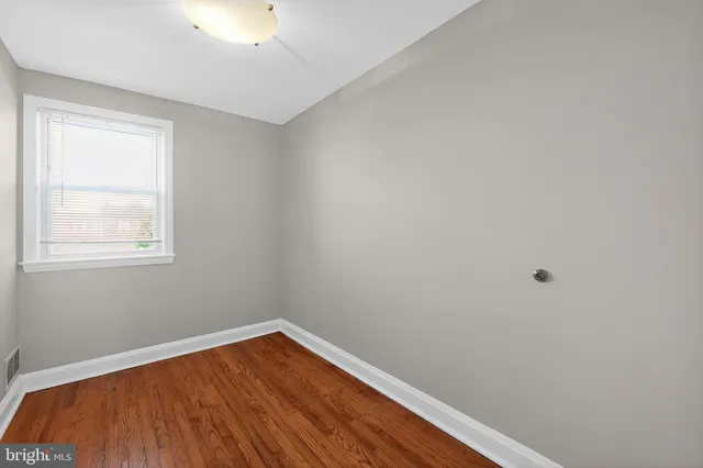 a view of small space with wooden floor and windows