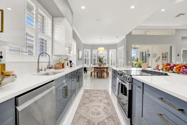 a large white kitchen with lots of counter top space