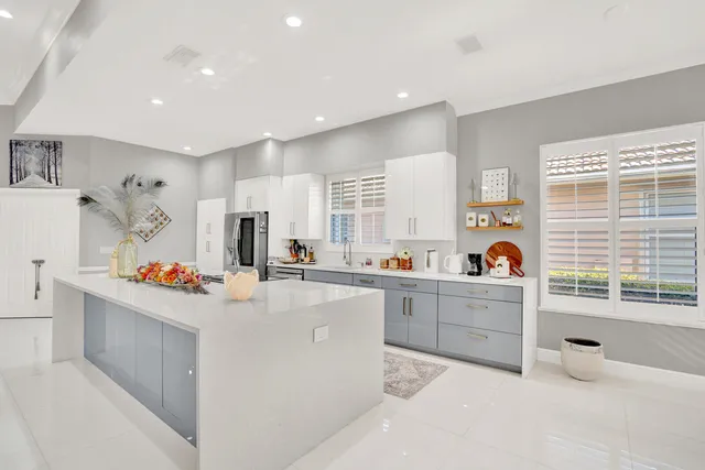 a dining room with furniture a chandelier and window
