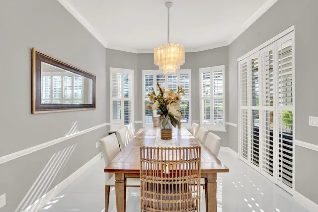 a living room filled with furniture chandelier and a table