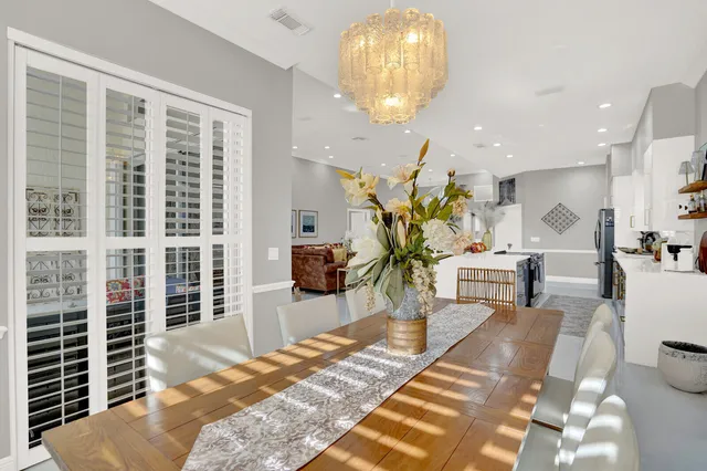 a spacious bedroom with a bed a couch and large window