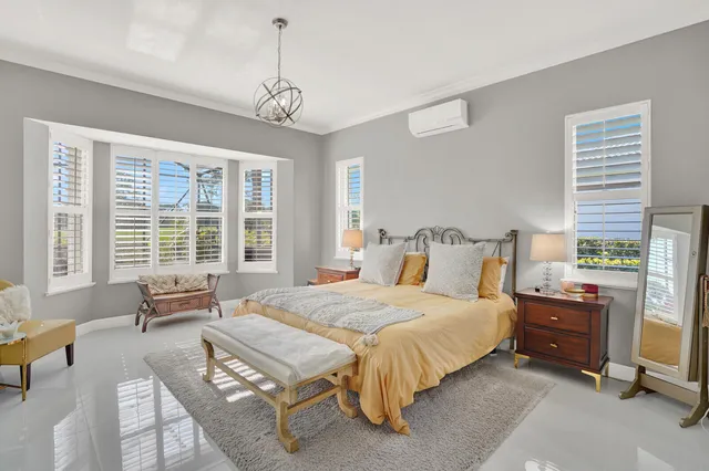 a bedroom with a bed a couch and dresser