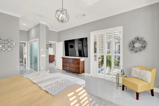 a spacious bedroom with a bed and flat screen tv