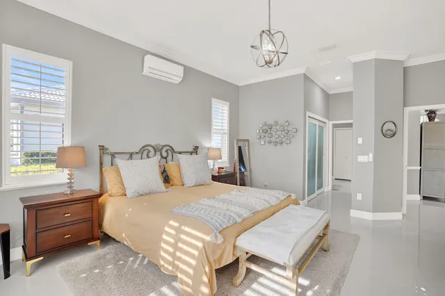 a view of a bedroom with a bed and a window