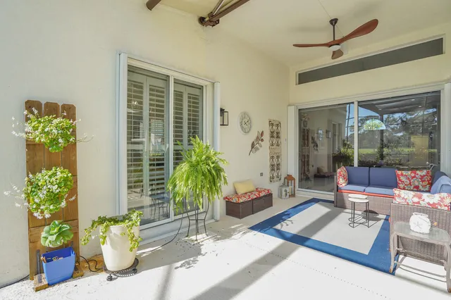 a view of a house with a big yard plants and large trees