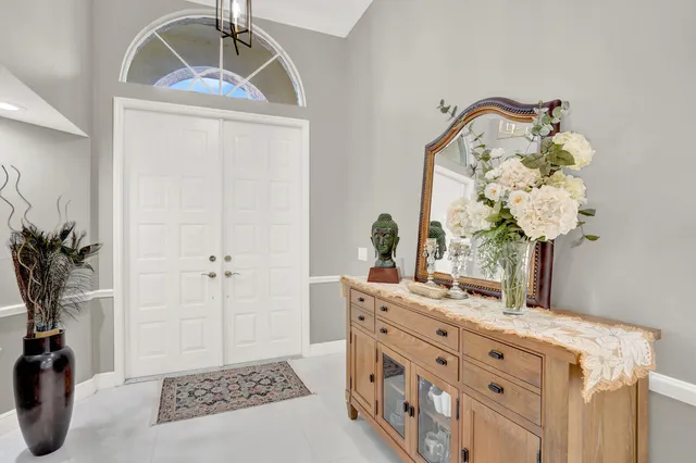 a bathroom with a sink a mirror and a potted plant
