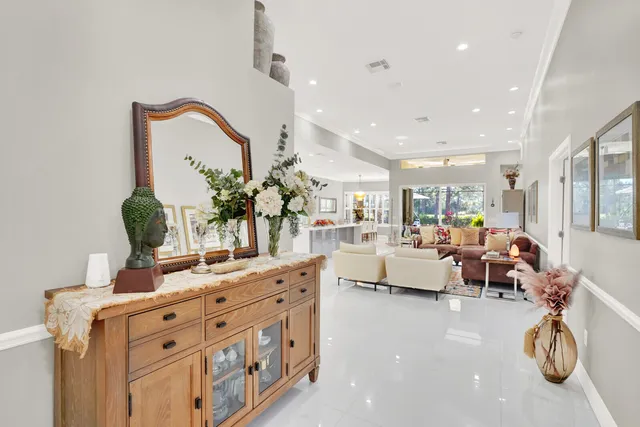 a living room with furniture white walls and kitchen view